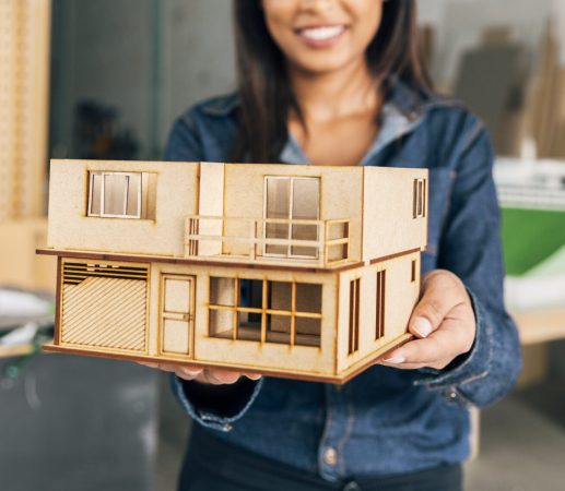 smiling-african-american-woman-showing-model-house